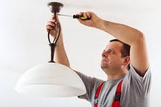 Electricians installing lighting