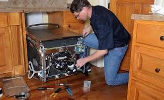 Electrician fixing dishwasher