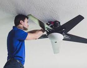 Electrician installing ceiling fan 